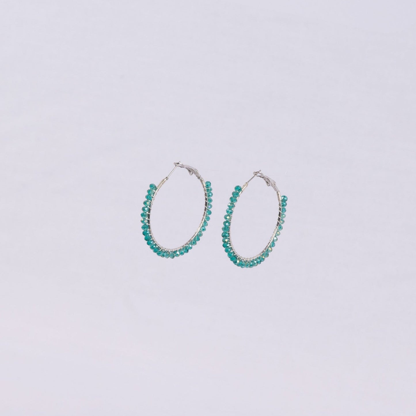 Pair of blue translucent beaded hoop earrings