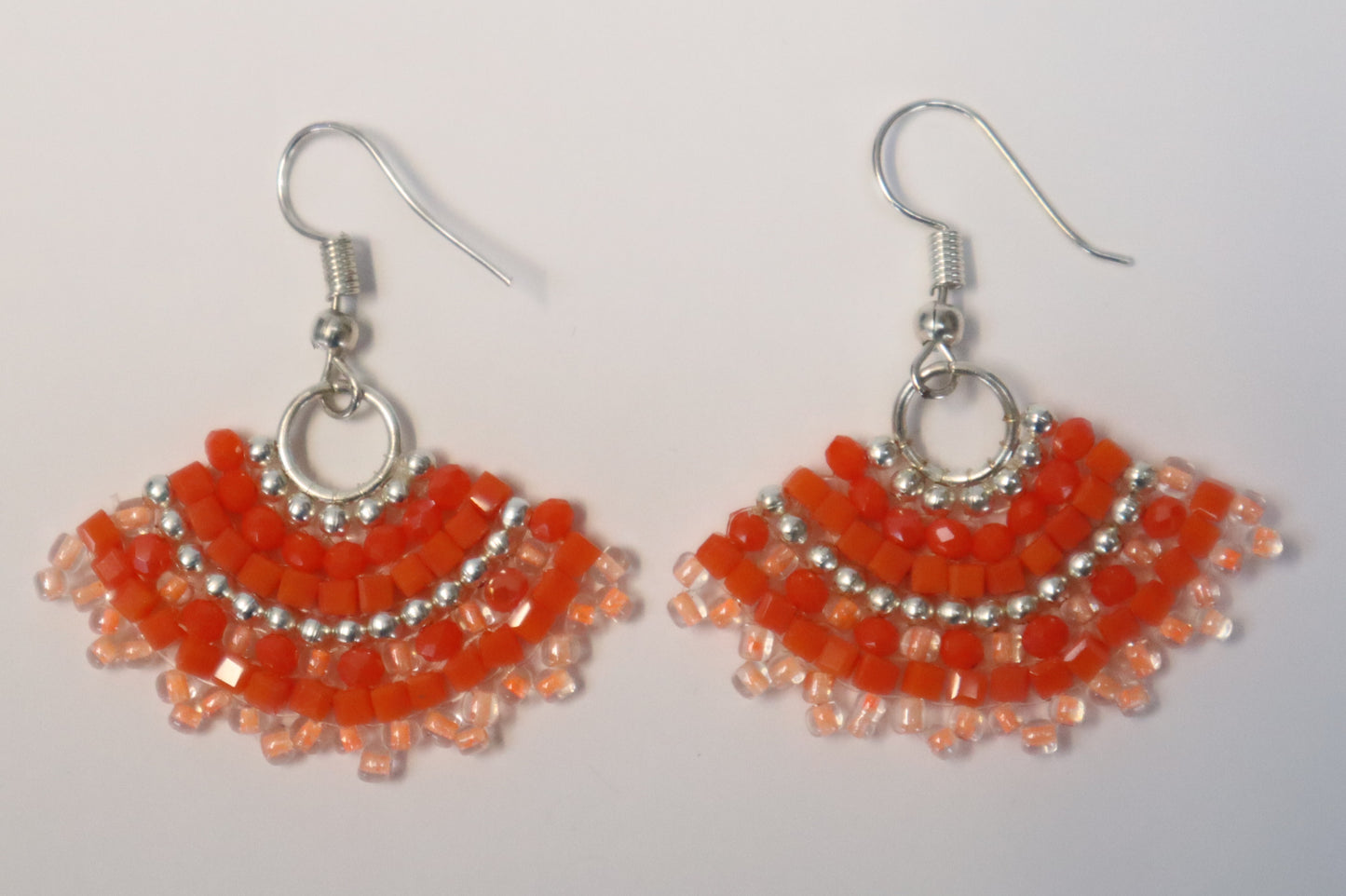 Pair of fan-shaped orange and silver beaded earrings