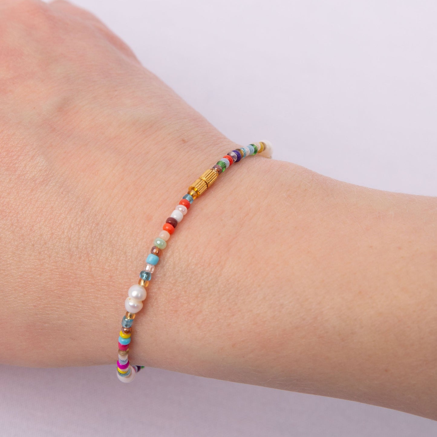 Photo showing the Kara Bracelet clasp. It is a small, gold screw clasp.