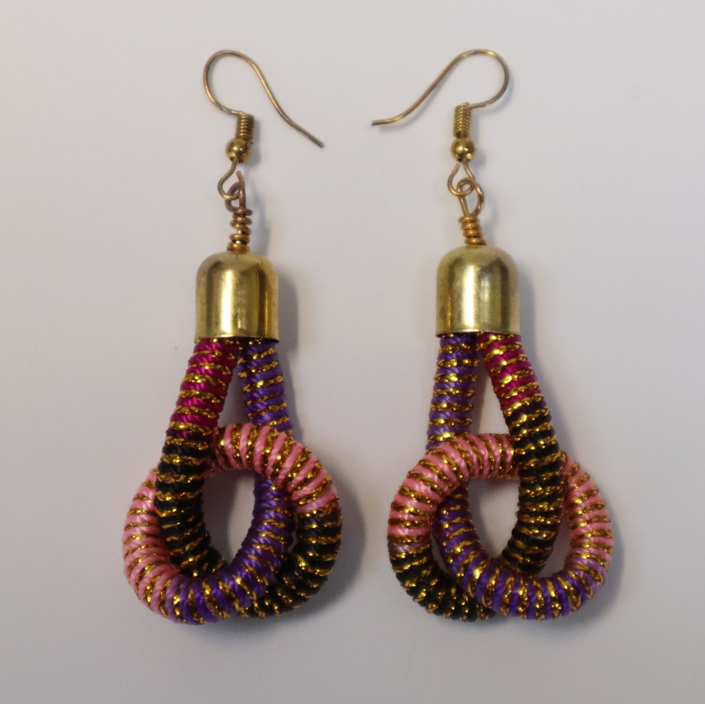 Pair of earrings with gold tops and multicoloured and gold knotted loops
