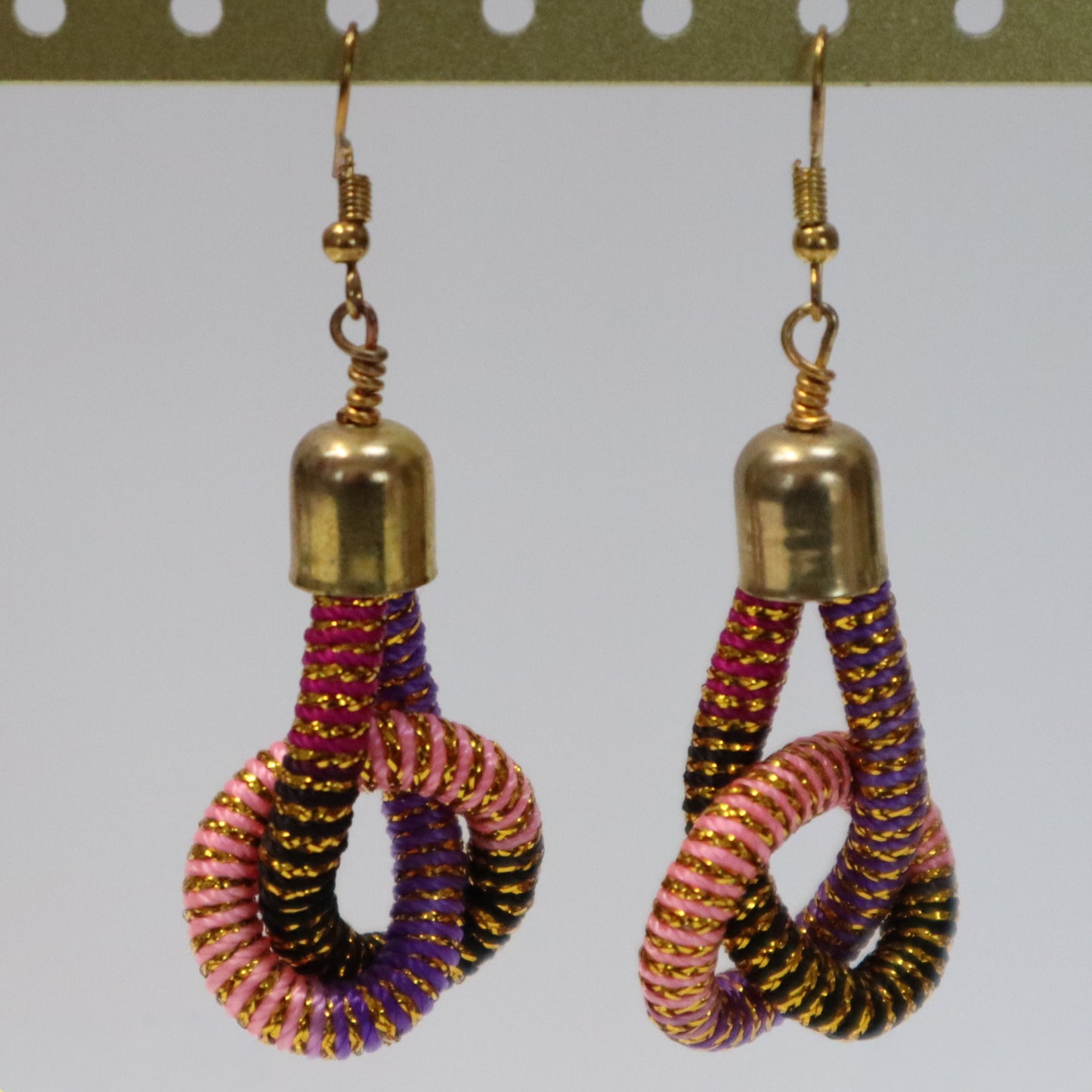 Pair of earrings with gold tops and multicolored and gold knotted loops
