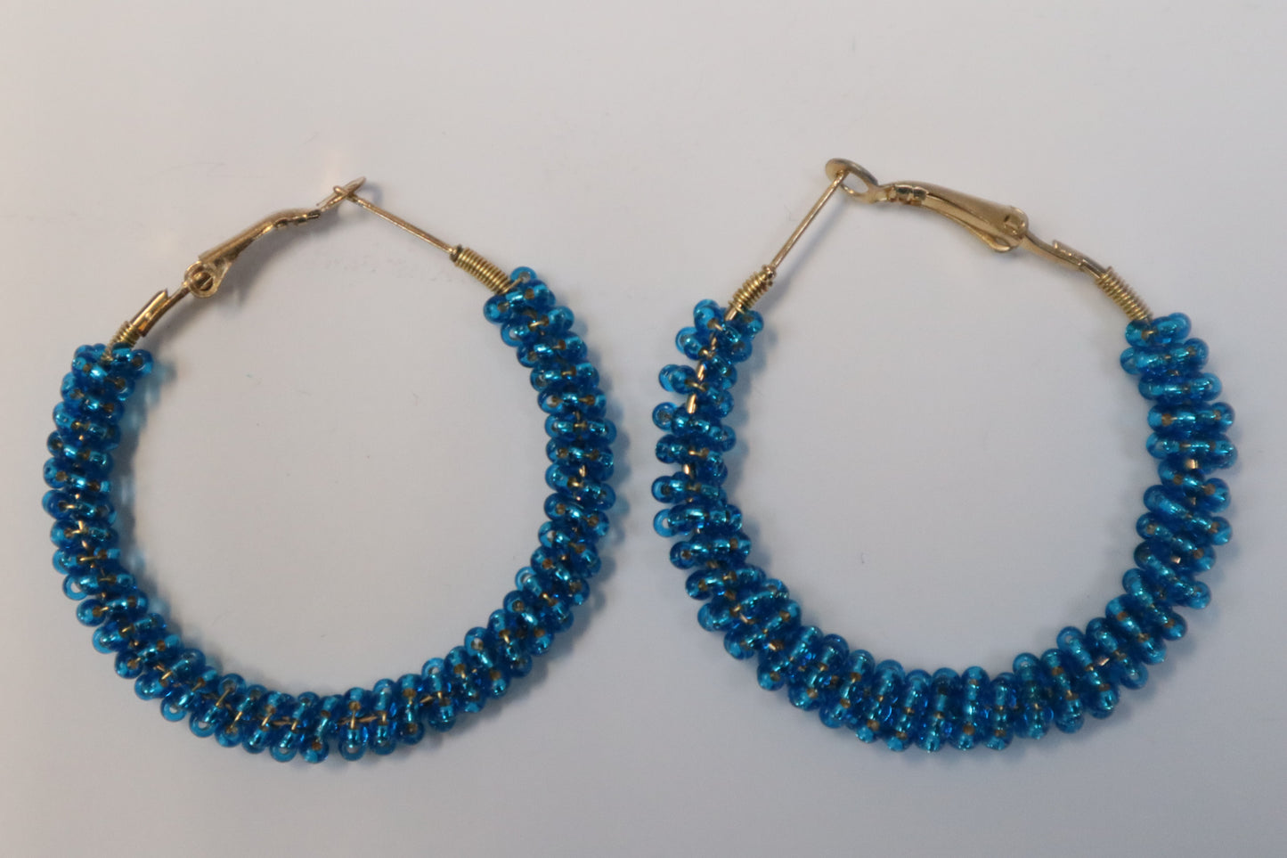 Pair of blue beaded hoop earrings