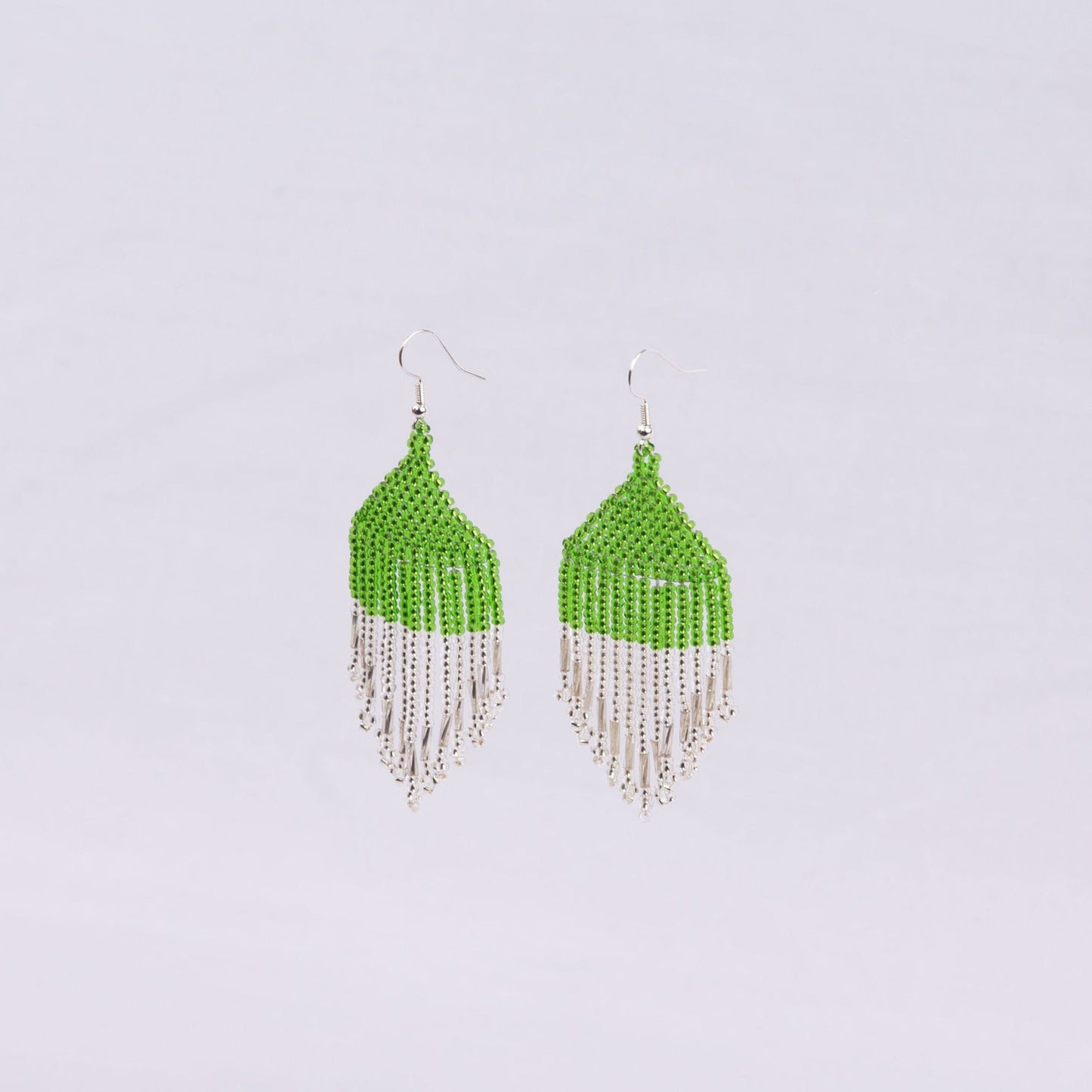 Pair of beaded earrings with green top and silver fringe