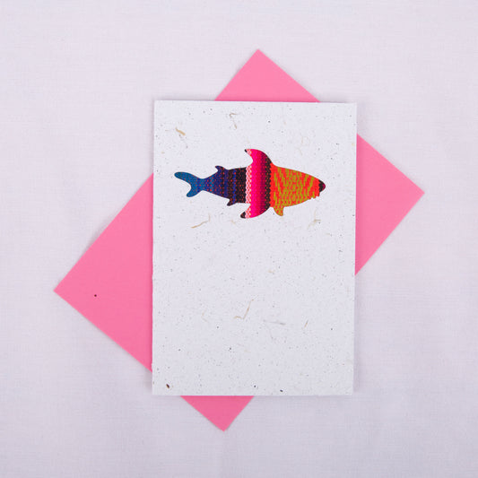 Colourful patterned shark cutout on a white card with a pink envelope underneath
