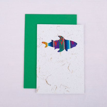 Colourful patterned shark cutout on a white card with a green envelope underneath