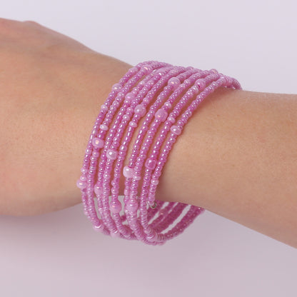 Pink beaded spiral bracelet on a wrist