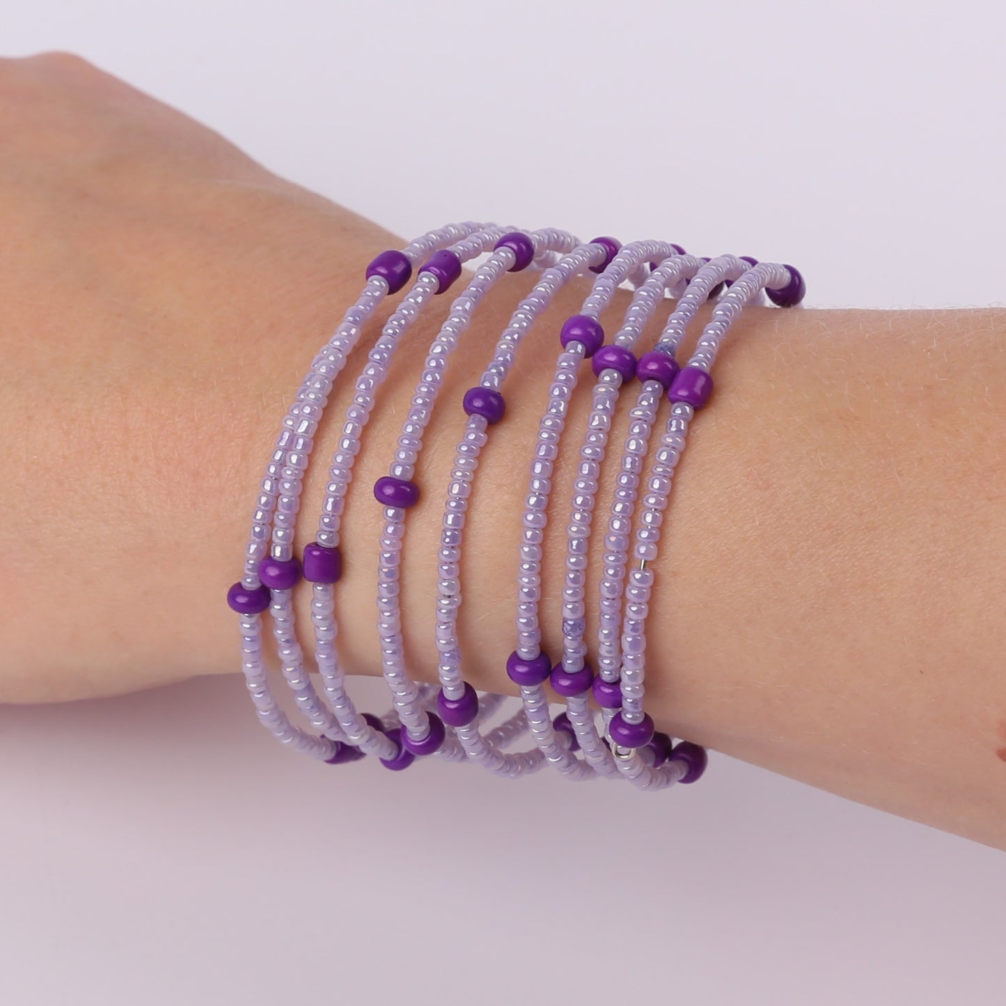 Purple beaded spiral bracelet on a wrist