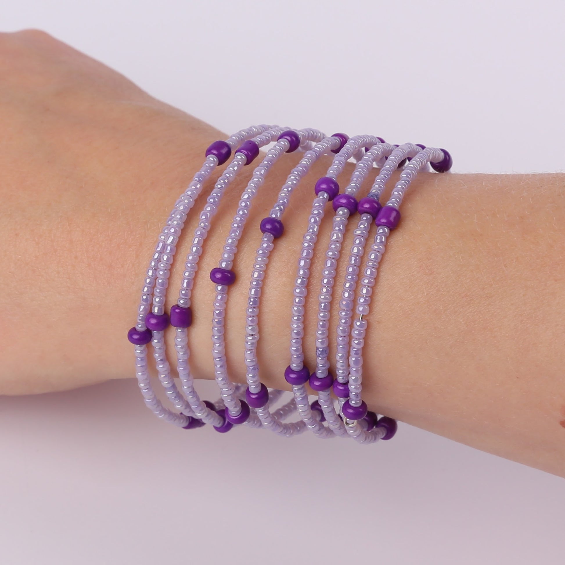 Purple beaded spiral bracelet on a wrist