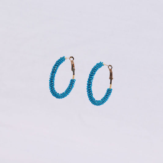 Pair of hoop earrings with blue beads around the hoop