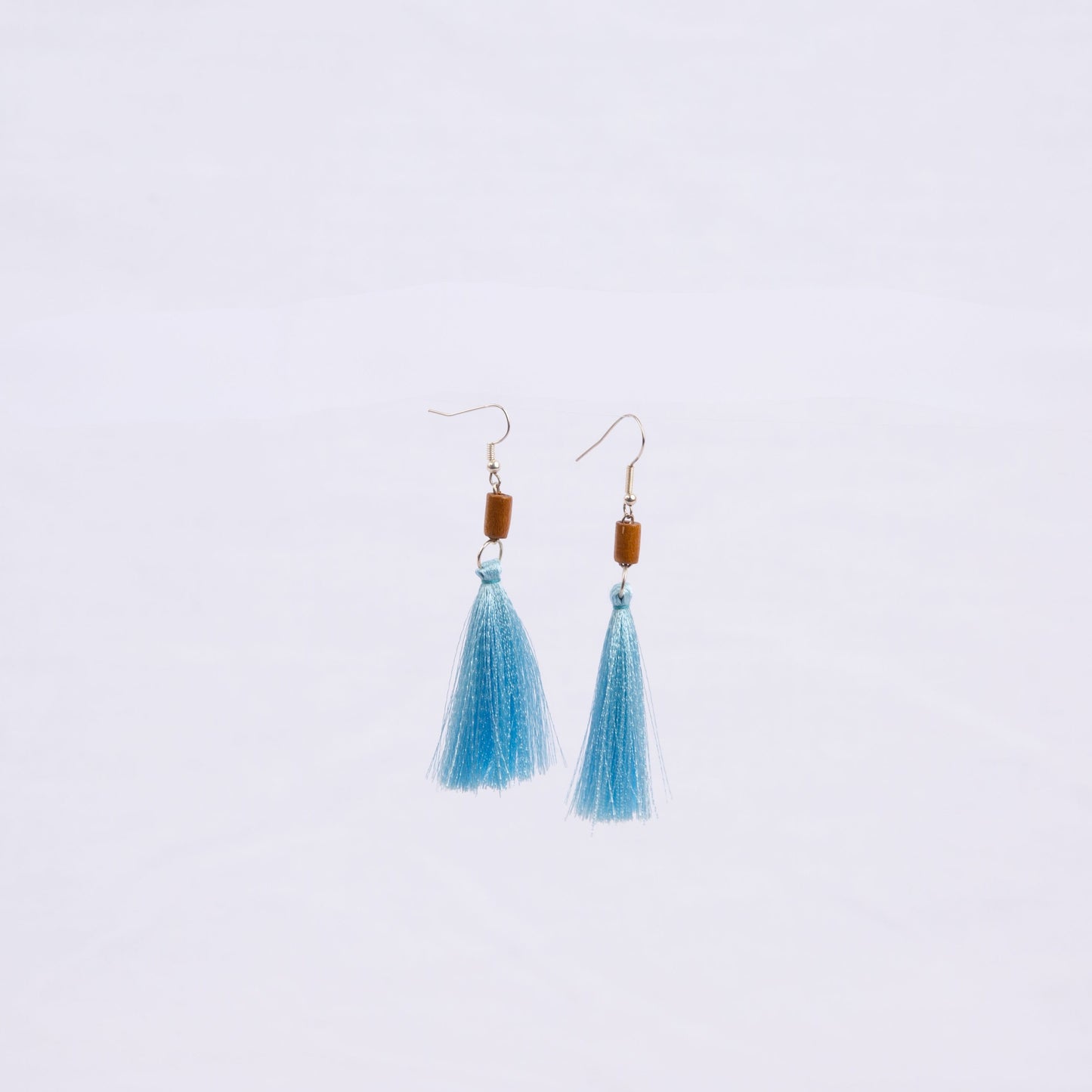 Pair of earrings with light blue tassels, wooden beads and gold hooks 