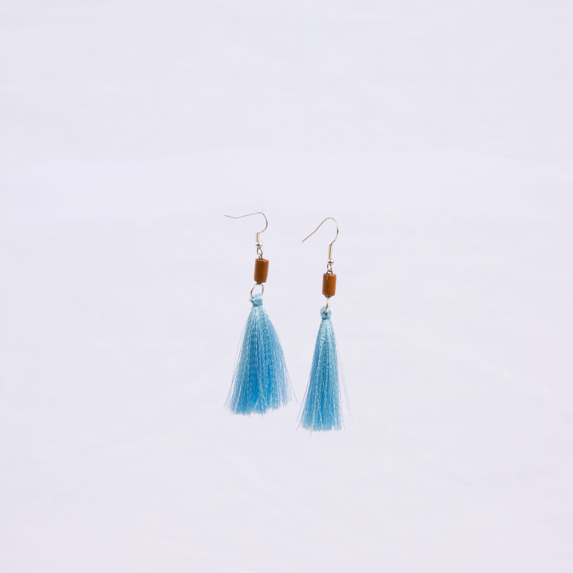 Pair of earrings with light blue tassels, wooden beads and gold hooks 