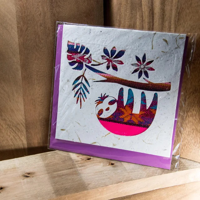An ethical, handmade sloth card, made from vibrant Ecuadorian fabrics.