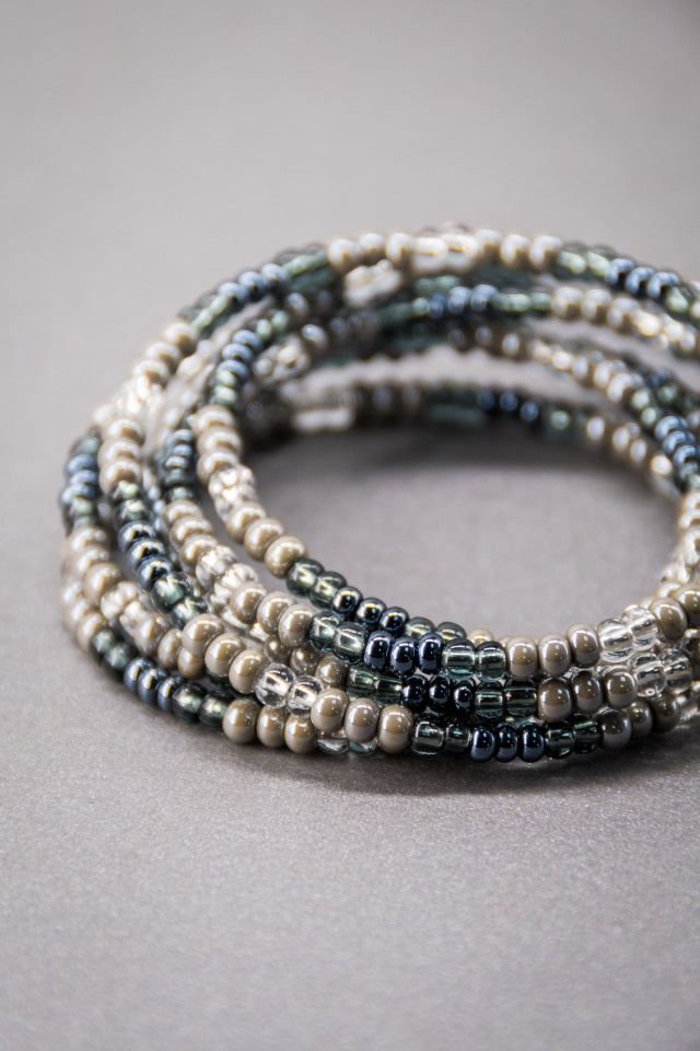 hand beaded beautiful bracelet is the perfect colour combination of gunmetal grey and silver with blue and green toned glass beads.